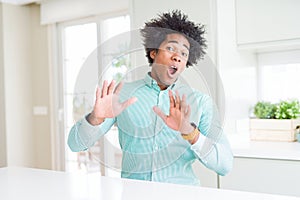 African American business man wearing elegant shirt afraid and terrified with fear expression stop gesture with hands, shouting in