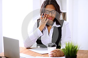 African American business woman is busy with paper job in office