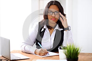 African american business woman is busy with paper job in office