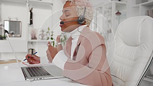 African American business woman wearing headset call with client