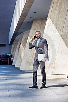 African American businessman with beard talking on cell phone, traveling, working in New York