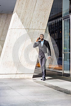 African American businessman with beard talking on cell phone, traveling, working in New York