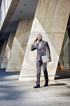 African American businessman with beard talking on cell phone, traveling, working in New York