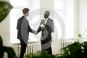 African American businessman congratulating partner with handsha