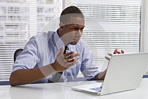 African American businessman at desk with computer, horizontal