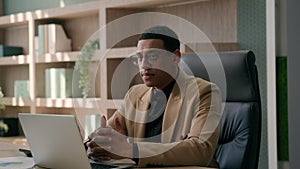 African American businessman ethnic puzzled man employer manager CEO entrepreneur working with laptop at office commerce