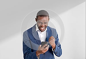 African American businessman in formal suit holding smartphone s