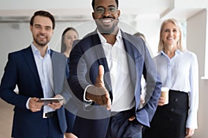 African American businessman greeting job candidate into team