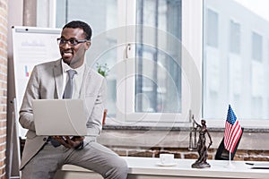 African american businessman holding laptop