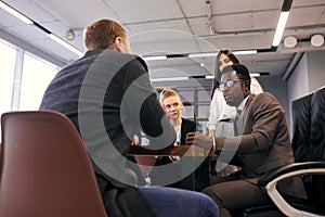 African american businessman holding meeting with young business people
