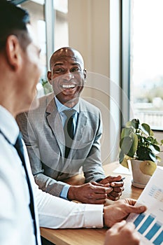 African American businessman laughing with a colleague in an off