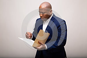 African American Businessman Looks Through Folder