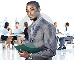 African american businessman in modern office with colleagues