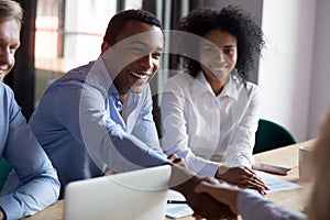 African American businessman shaking hand of business partner at meeting