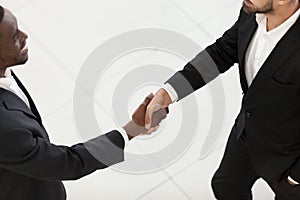 African American businessman shaking hand employee in office