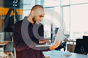 African american businessman sitting at a computer in his startup office