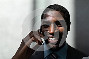 African-American businessman talking on mobile phone in office