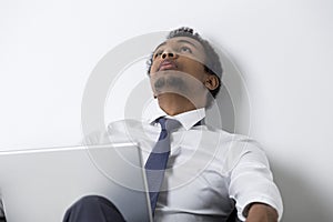 African American businessman thinking in armchair