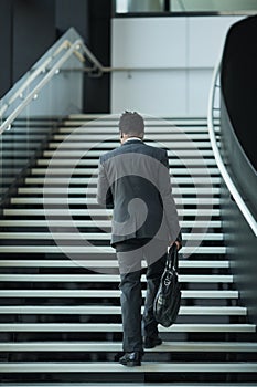 African American Businessman Walking Up Stairs