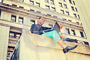 African American businessman working on street in New York