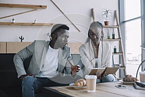 african american businesspeople discussing work during business meeting