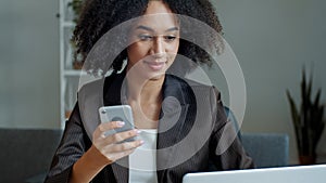 African american businesswoman freelancer student girl woman sit at home office read sms email on mobile phone work