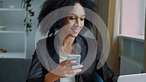 African american businesswoman freelancer student girl woman sit at home office read sms email on mobile phone work