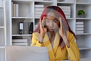 African American businesswoman has fatigue and headaches from working in the office.