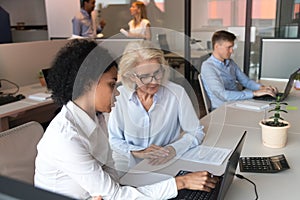 African American businesswoman with mature employee working together