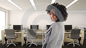 African American Businesswoman In an Office Looking Shy or Embarrassed