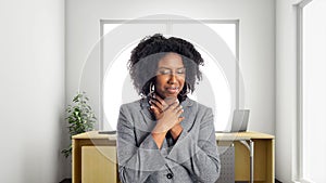 African American Businesswoman In an Office With Sore Throat
