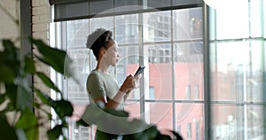 African American businesswoman stands by the window, with copy space