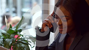 African american businesswoman talking on the phone with business partner