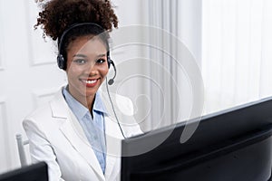 African American businesswoman wearing headset working in crucial office