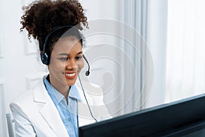 African American businesswoman wearing headset working in crucial office
