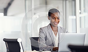 African american businesswoman working on laptop in office