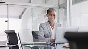 African american businesswoman working on laptop in office