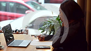 African american businesswoman working with laptop and papers