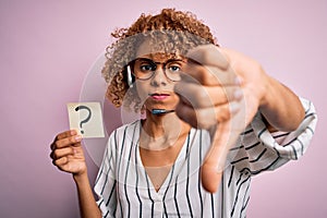 African american call center agent woman using headset holding paper with question mark with angry face, negative sign showing