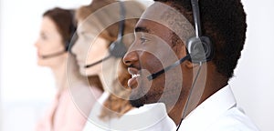 African american call operator in headset. Call center business or customer service concept