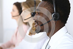 African american call operator in headset. Call center business or customer service concept