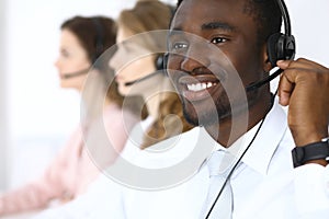 African american call operator in headset. Call center business or customer service concept