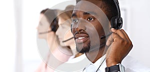 African american call operator in headset. Call center business or customer service concept