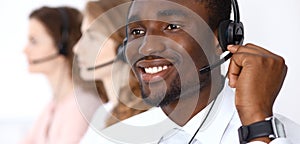 African american call operator in headset. Call center business or customer service concept