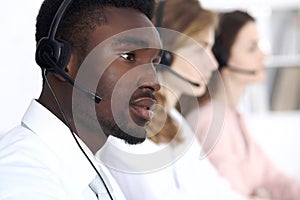 African american call operator in headset. Call center business or customer service concept