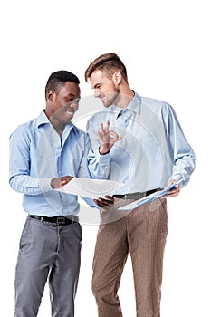 African-American and Caucasian businessman looking at documents