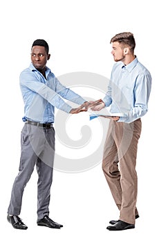 African-American and Caucasian businessman looking at documents