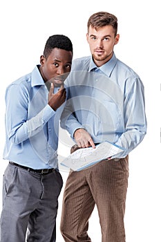 African-American and Caucasian businessman looking at documents