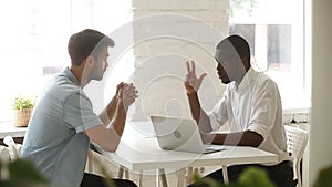 African american and caucasian businessmen negotiating handshaking over office desk