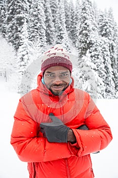 African American Cheerful black man in ski suit in snowy winter outdoors, Almaty, Kazakhstan